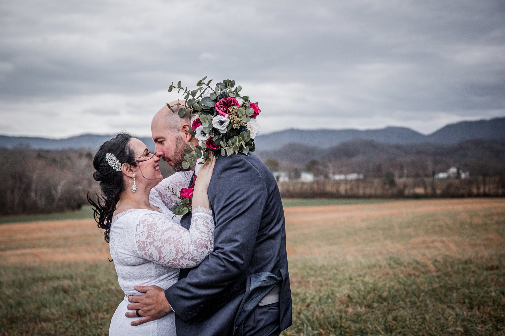 Bride and groom in front of the mountains at Chapel in the Hollow for a Gatlinburg elopement. 