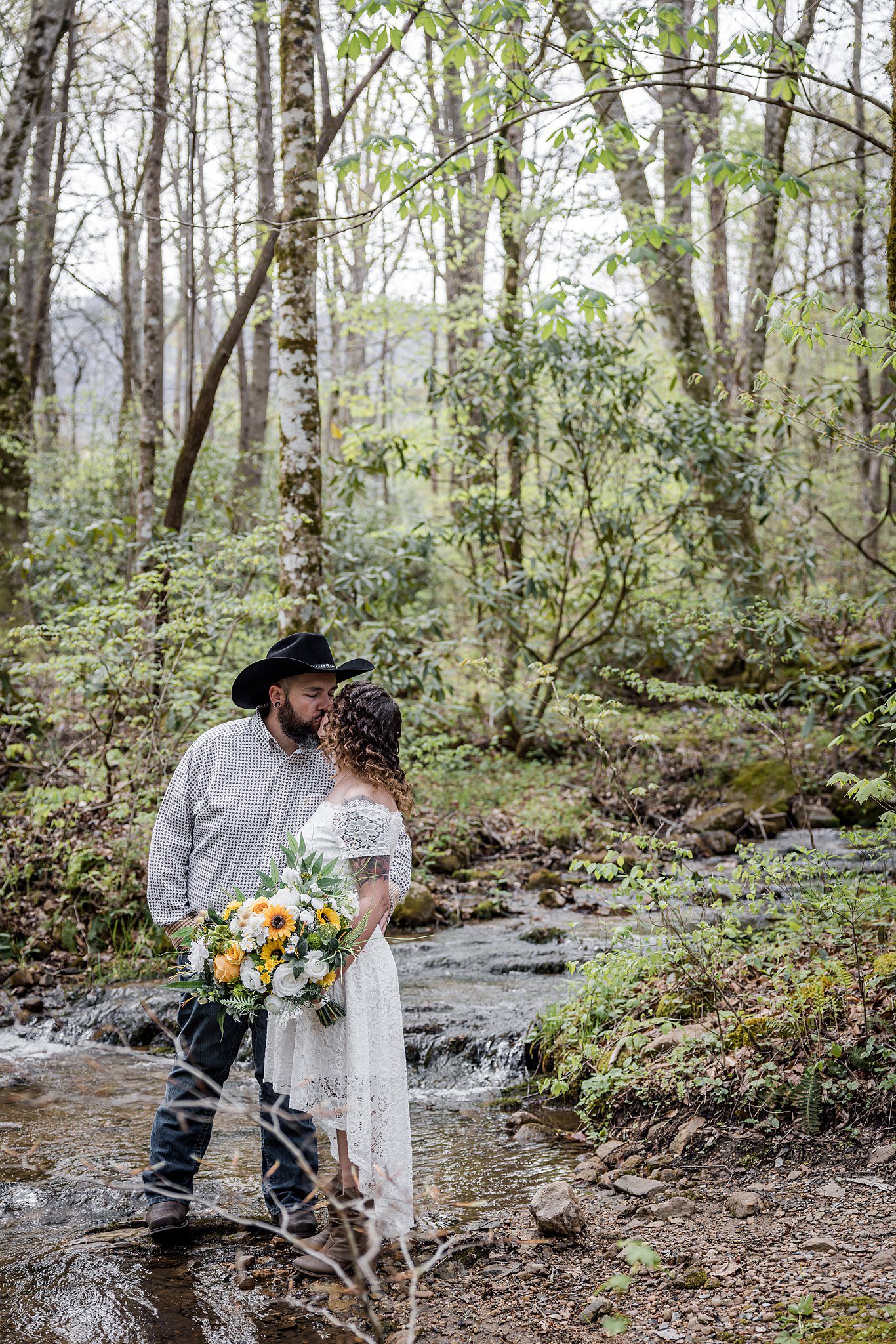 bride and groom at creek