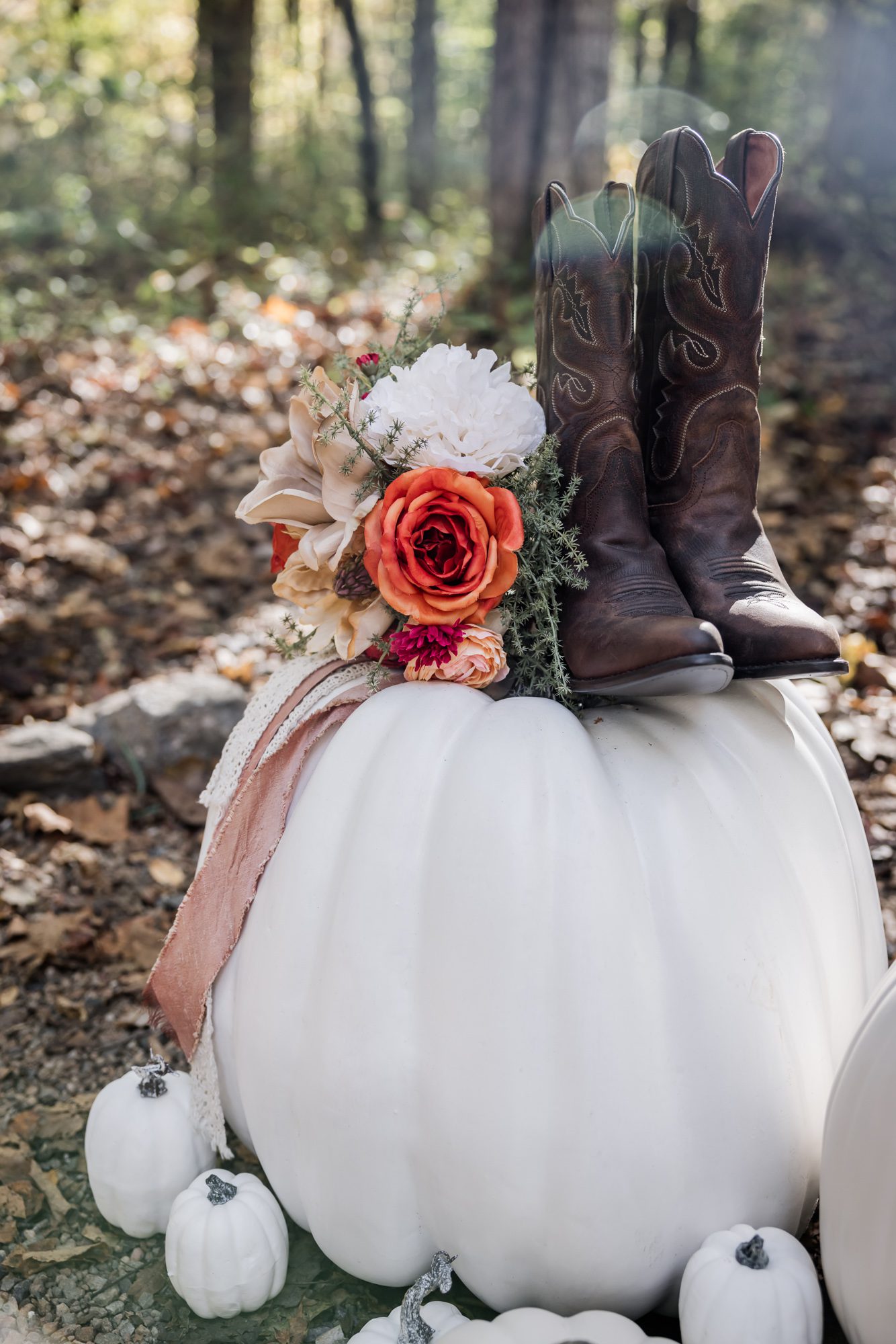 Boots and Bouquet on a pumpkin