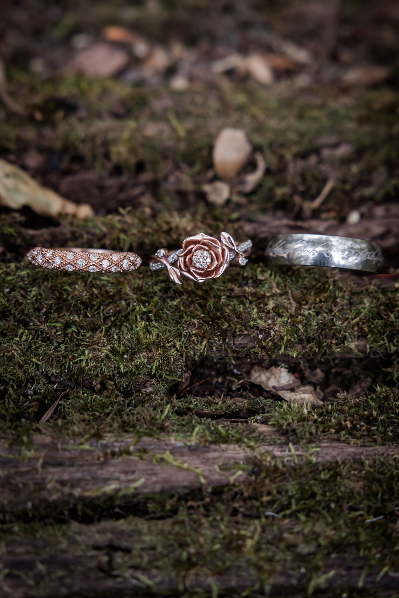 Rose Gold Wedding Ring on mossy log