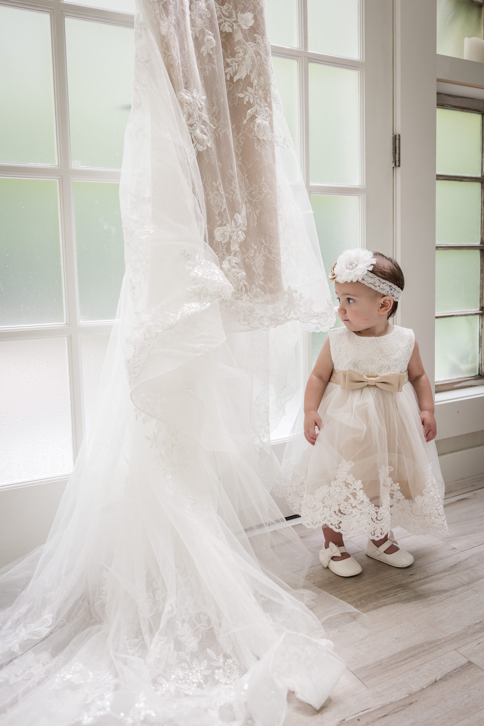 baby looking at wedding dress